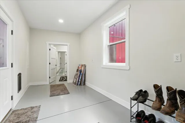 a bedroom with a bed and a large window