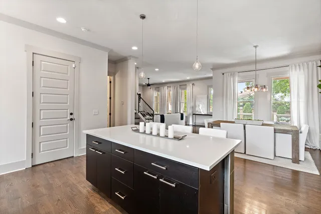 a kitchen with a sink a stove a refrigerator and white cabinets