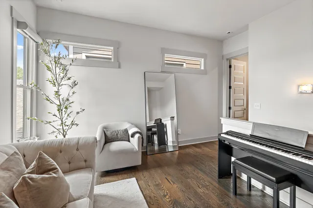 a living room with furniture and a piano