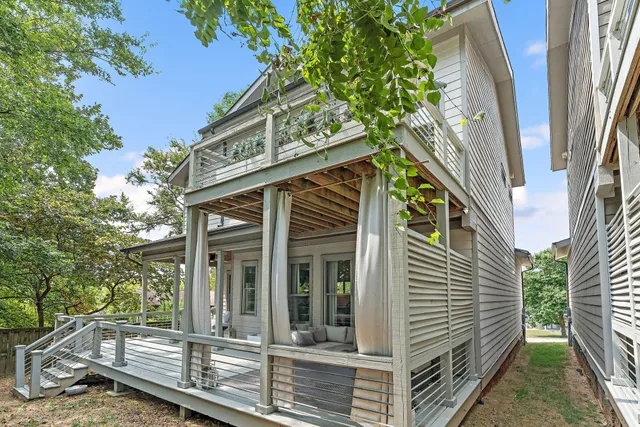 a backyard of a house with a lake view and a bench
