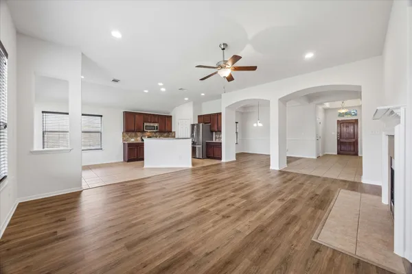 a kitchen with stainless steel appliances granite countertop a refrigerator stove microwave and sink