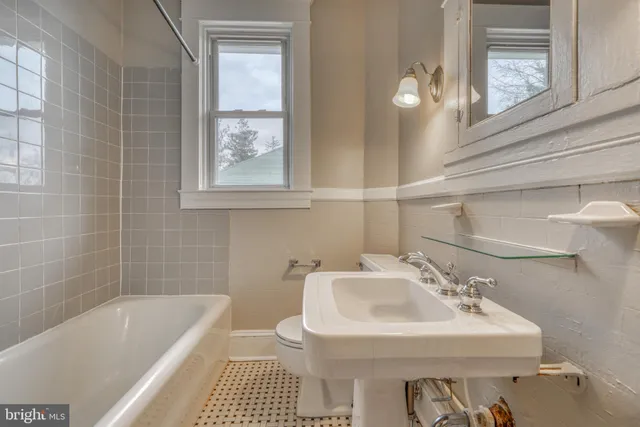 a bathroom with a sink a toilet and bathtub