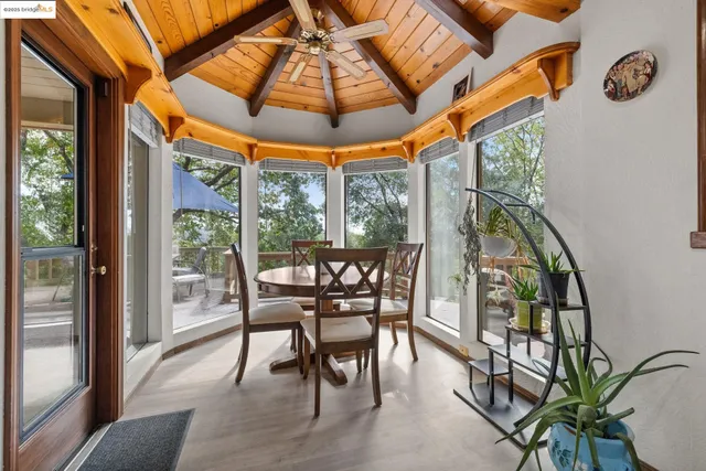 a dining room with furniture and wooden floor