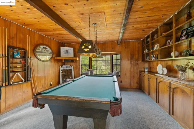 a room with lots of wooden furniture and a window
