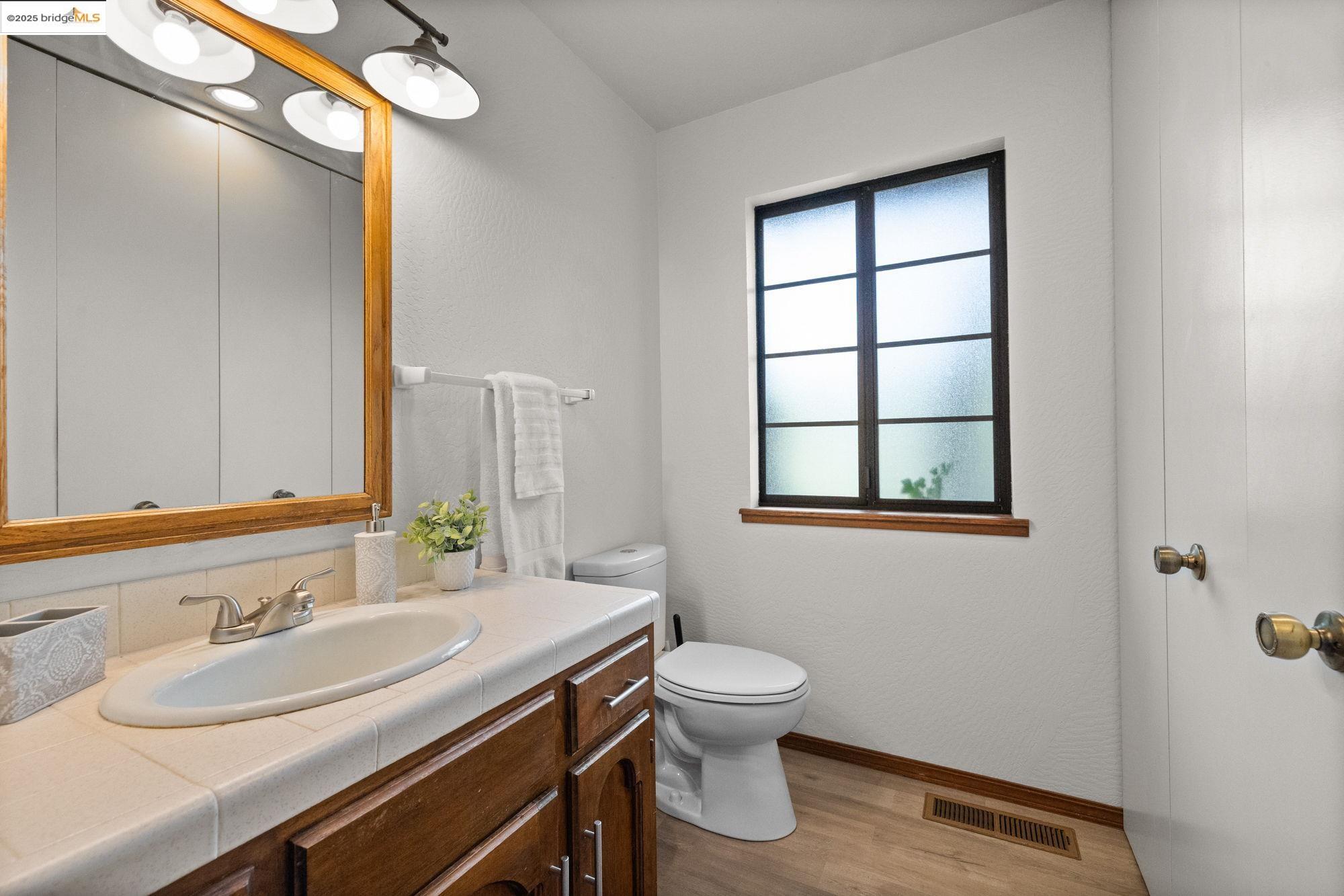 21950 Paseo De Los Portales Road Sonora, CA 95370 - Photo 23 of 47 a bathroom with a granite countertop sink toilet and mirror