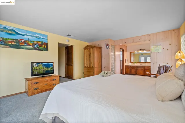 a bedroom with a bed and dresser