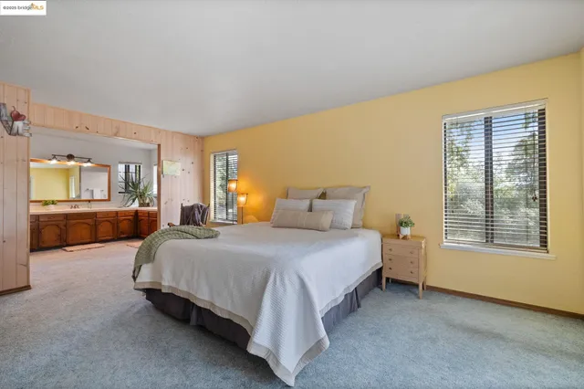 a spacious bedroom with a bed and window