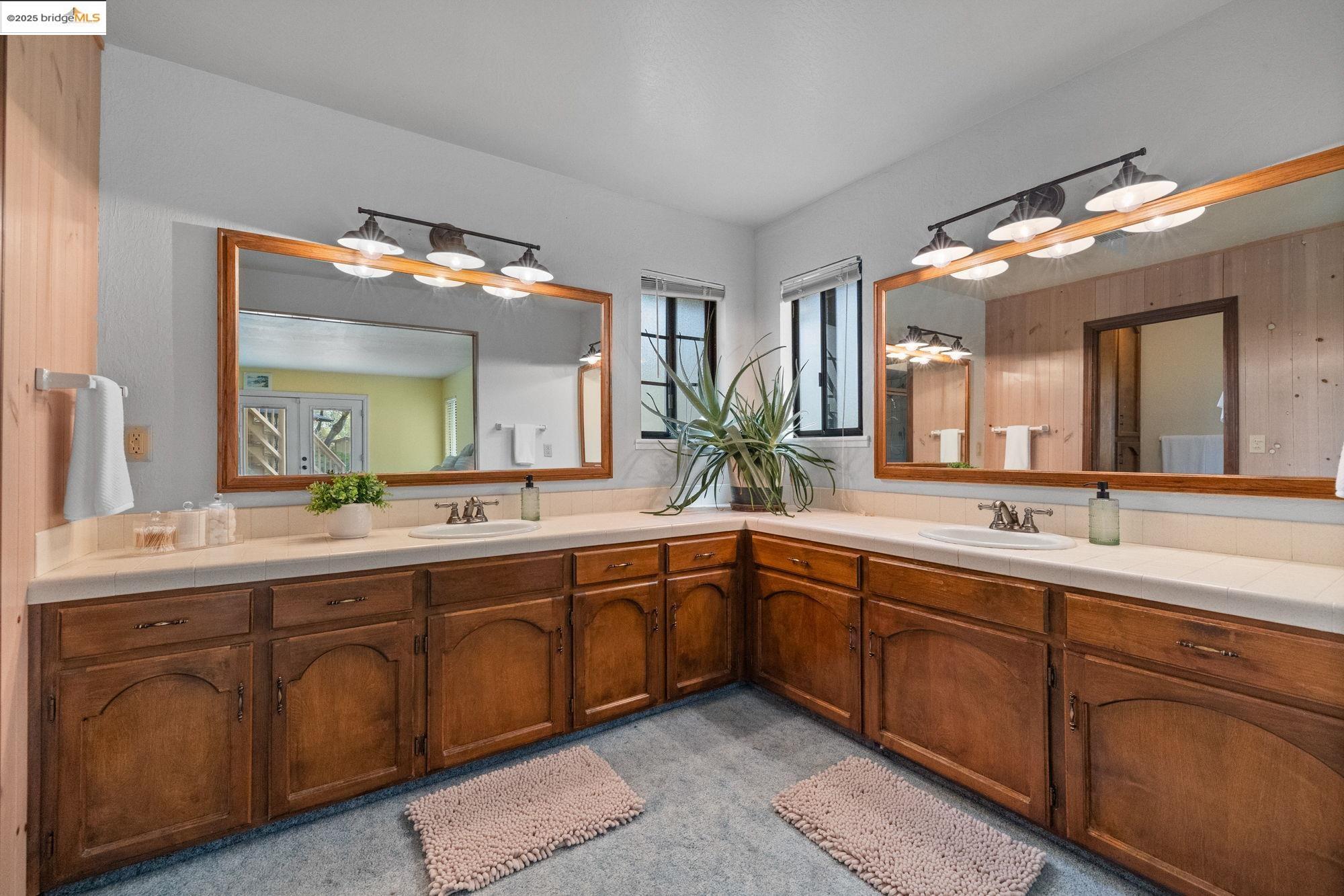 21950 Paseo De Los Portales Road Sonora, CA 95370 - Photo 29 of 47 a spacious bathroom with a double vanity sink and a mirror