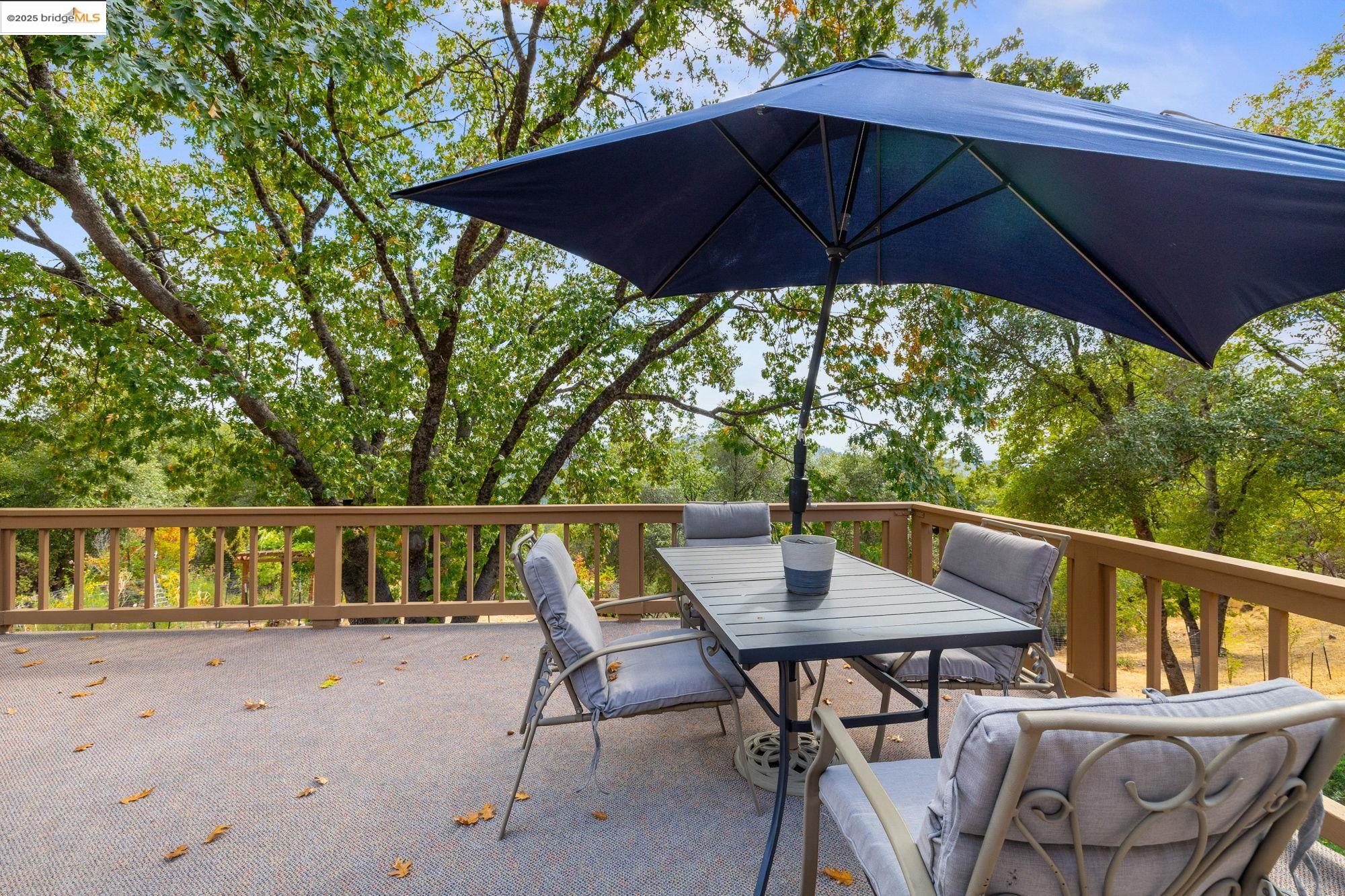 21950 Paseo De Los Portales Road Sonora, CA 95370 - Photo 37 of 47 a patio with wooden floor table and chairs