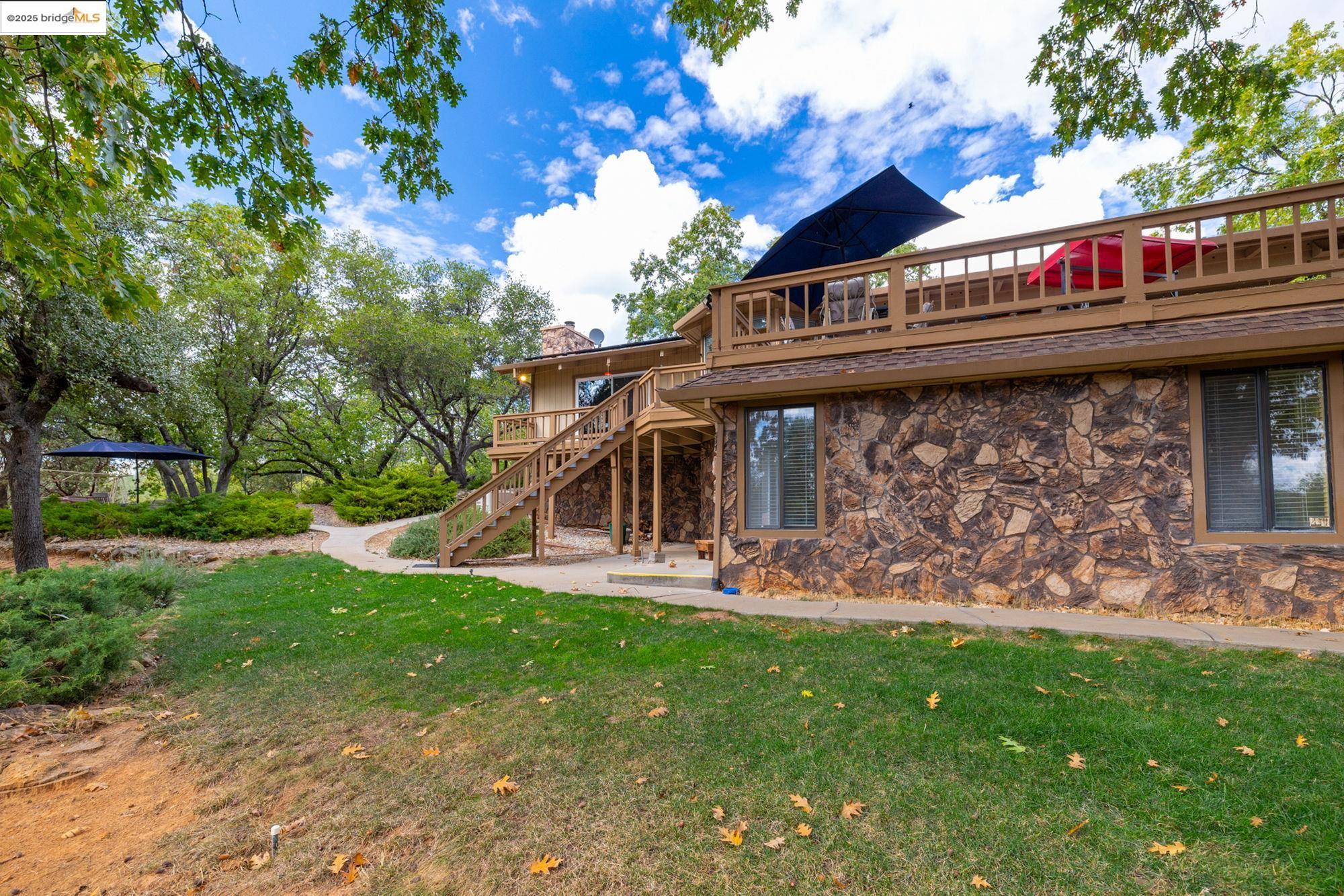 21950 Paseo De Los Portales Road Sonora, CA 95370 - Photo 40 of 47 a view of a house with a yard balcony and sitting area