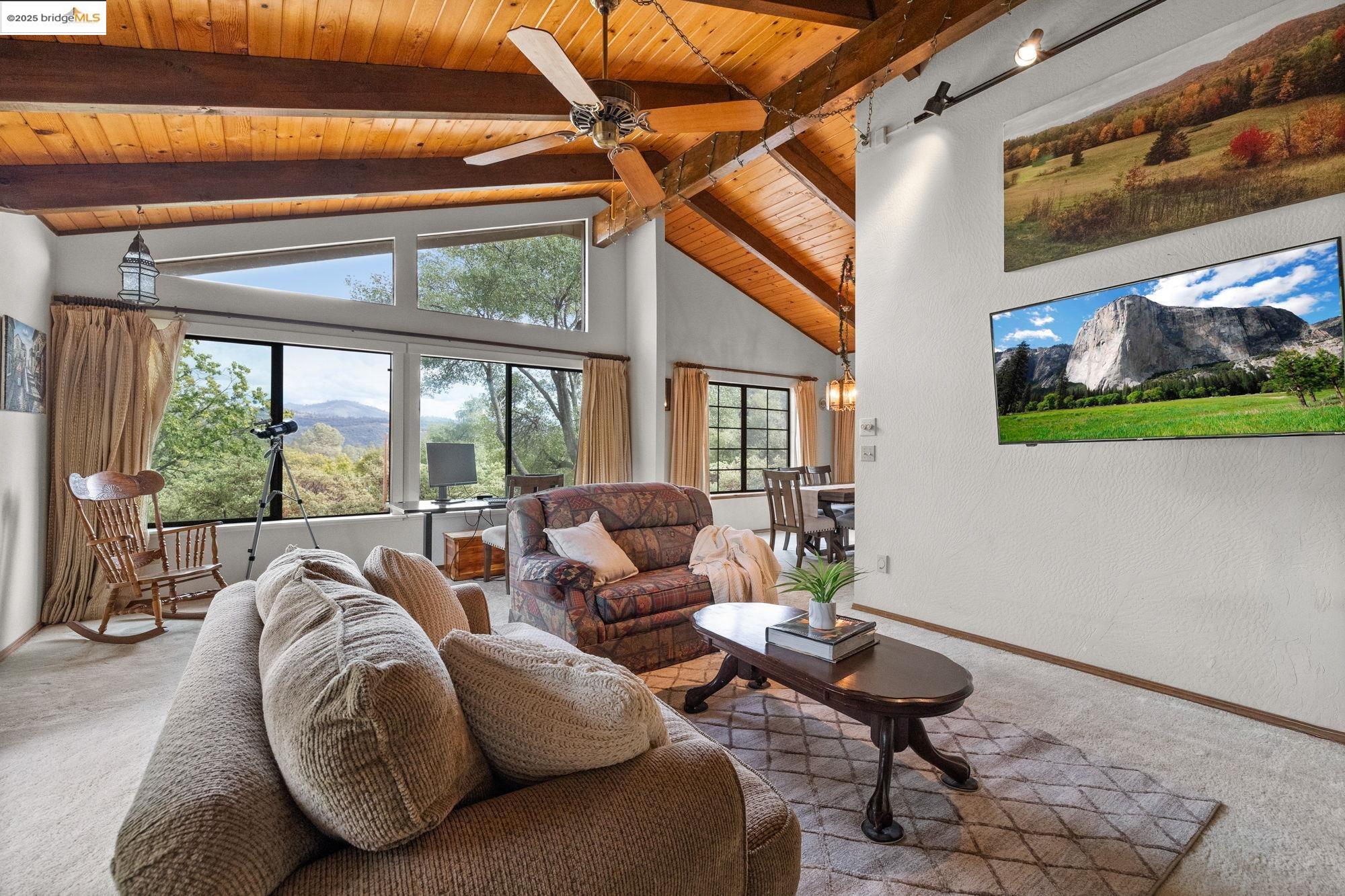 21950 Paseo De Los Portales Road Sonora, CA 95370 - Photo 7 of 47 a living room with patio furniture and a floor to ceiling window
