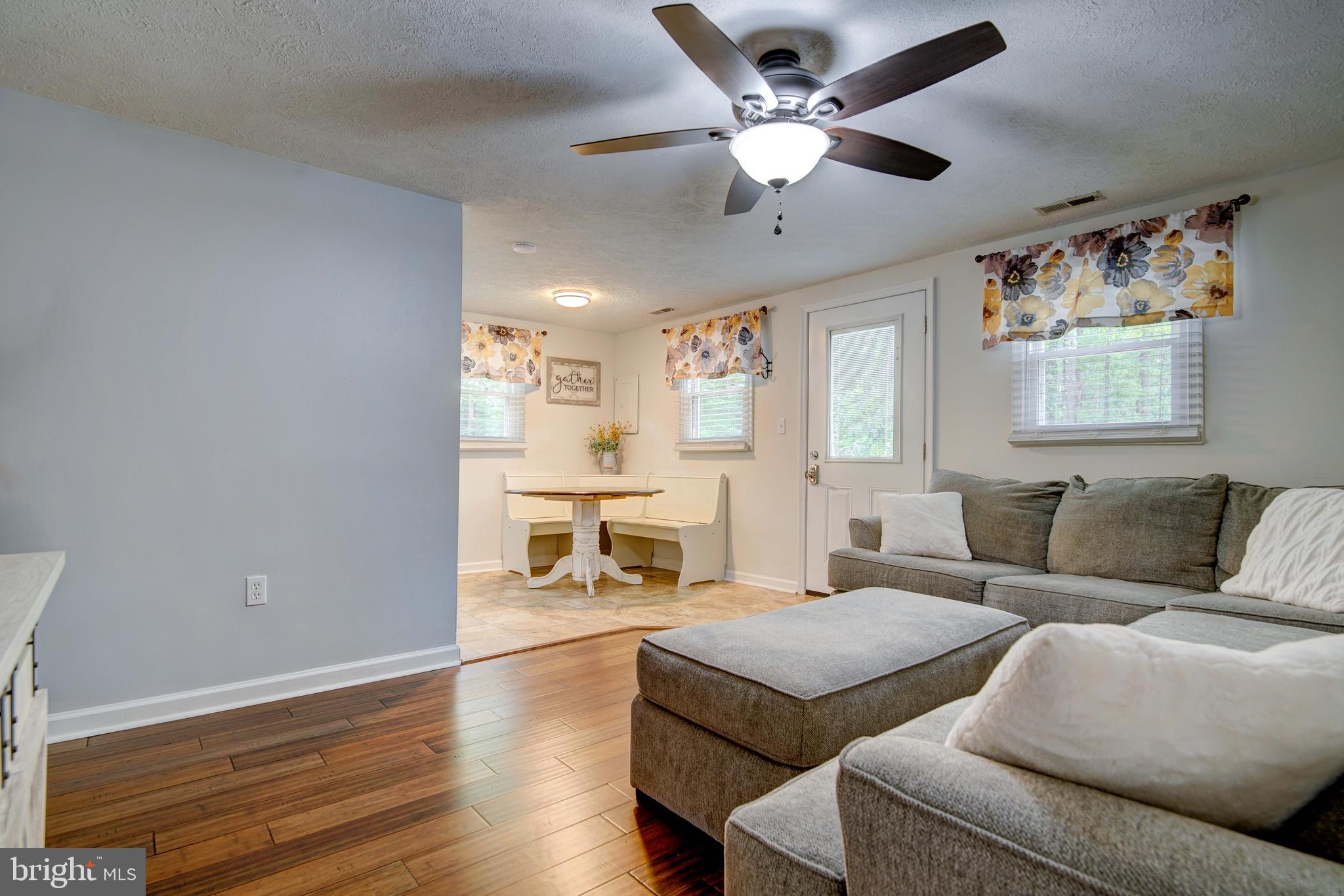 245 Newtown Road Solomons, MD 20688 - Photo 6 of 26 a living room with furniture fireplace and a flat screen tv