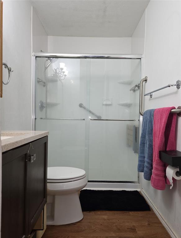 2908 East 15th Street Plano, TX 75074 - Photo 4 of 6 a bathroom with a toilet and a shower