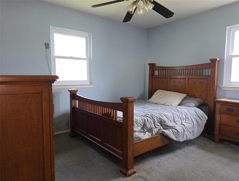 2908 East 15th Street Plano, TX 75074 - Photo 5 of 6 a bed sitting in a bedroom next to a window