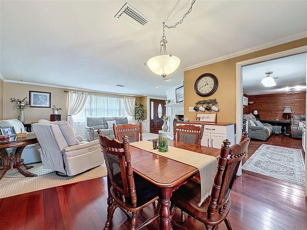 1602 Alder Way Brandon, FL 33510 - Photo 12 of 64 a view of a dining room with furniture window and wooden floor