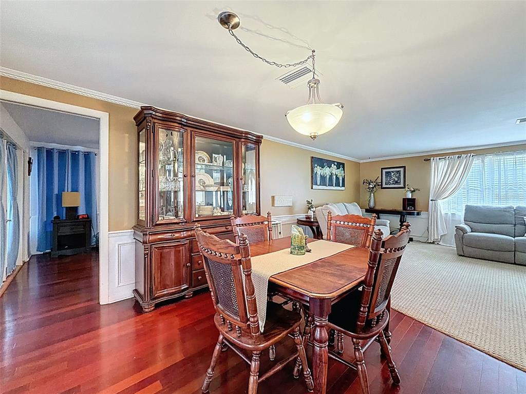 1602 Alder Way Brandon, FL 33510 - Photo 13 of 64 a view of a dining room with furniture window and wooden floor