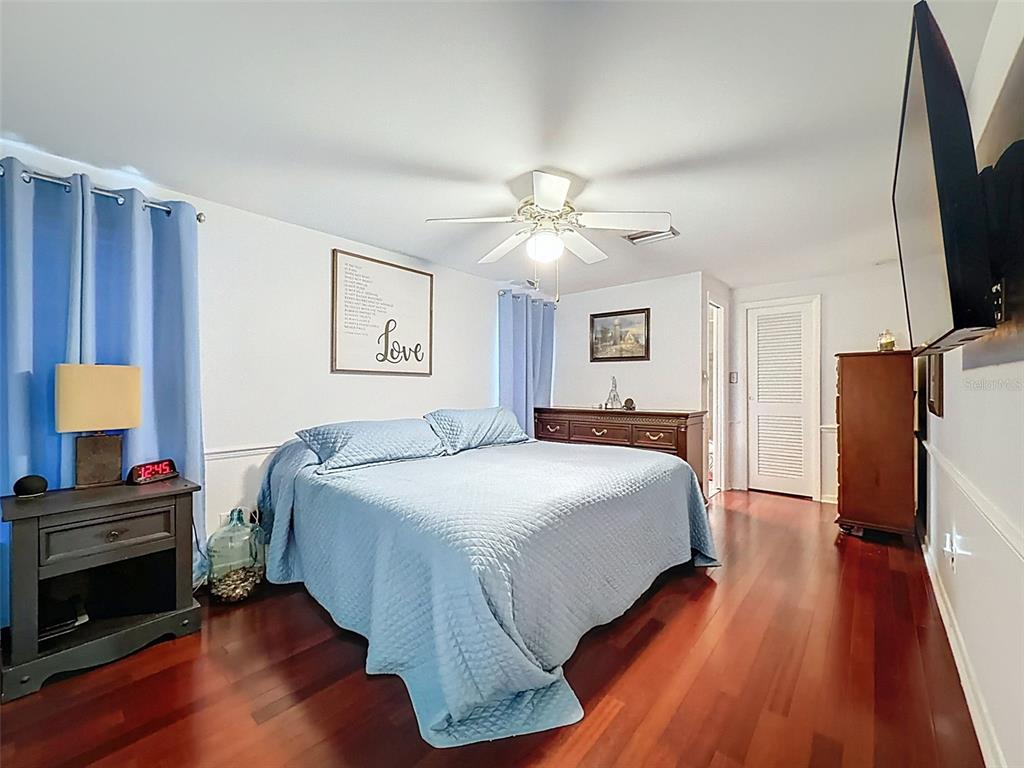 1602 Alder Way Brandon, FL 33510 - Photo 15 of 64 a bedroom with a bed and a flat screen tv