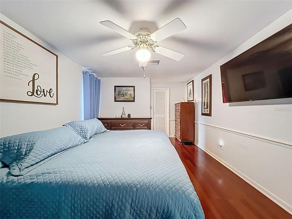 1602 Alder Way Brandon, FL 33510 - Photo 16 of 64 a bedroom with a large bed and a flat screen tv