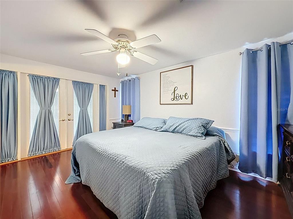 1602 Alder Way Brandon, FL 33510 - Photo 18 of 64 a bedroom with a large bed and a chandelier