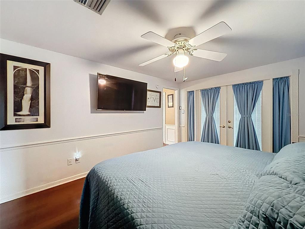1602 Alder Way Brandon, FL 33510 - Photo 21 of 64 a bedroom with a large bed and a flat screen tv