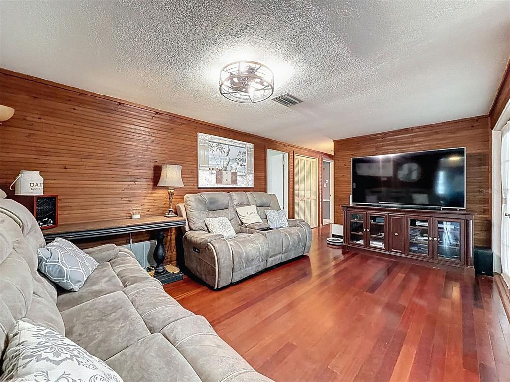 1602 Alder Way Brandon, FL 33510 - Photo 27 of 64 a living room with furniture and a flat screen tv