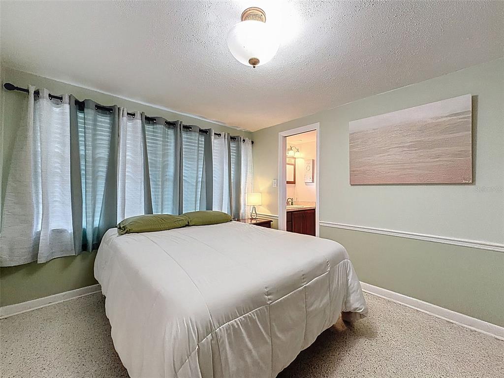 1602 Alder Way Brandon, FL 33510 - Photo 31 of 64 a bedroom with a bed and a window