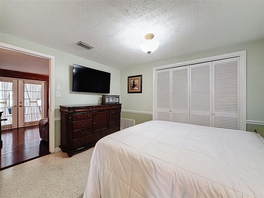1602 Alder Way Brandon, FL 33510 - Photo 32 of 64 a bedroom with a bed and a flat screen tv
