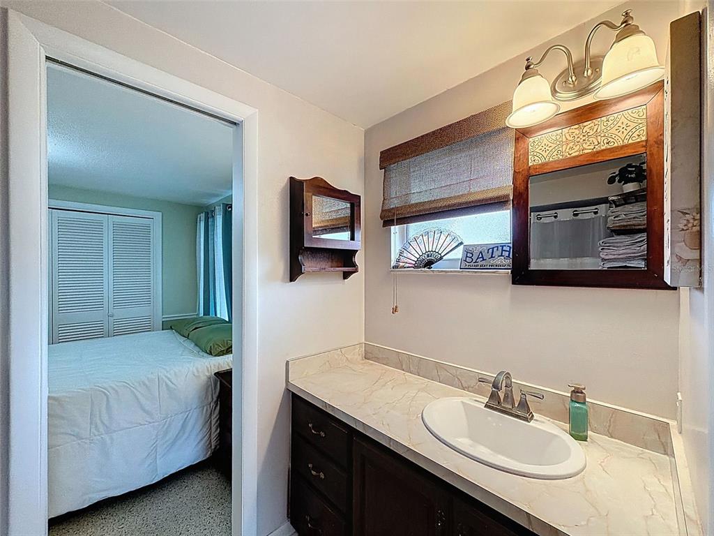 1602 Alder Way Brandon, FL 33510 - Photo 36 of 64 a en suite bathroom with a double vanity sink and mirror