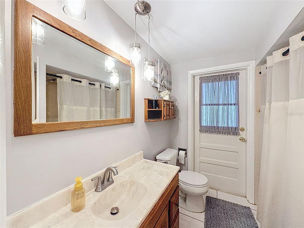 1602 Alder Way Brandon, FL 33510 - Photo 39 of 64 a bathroom with a sink toilet and mirror