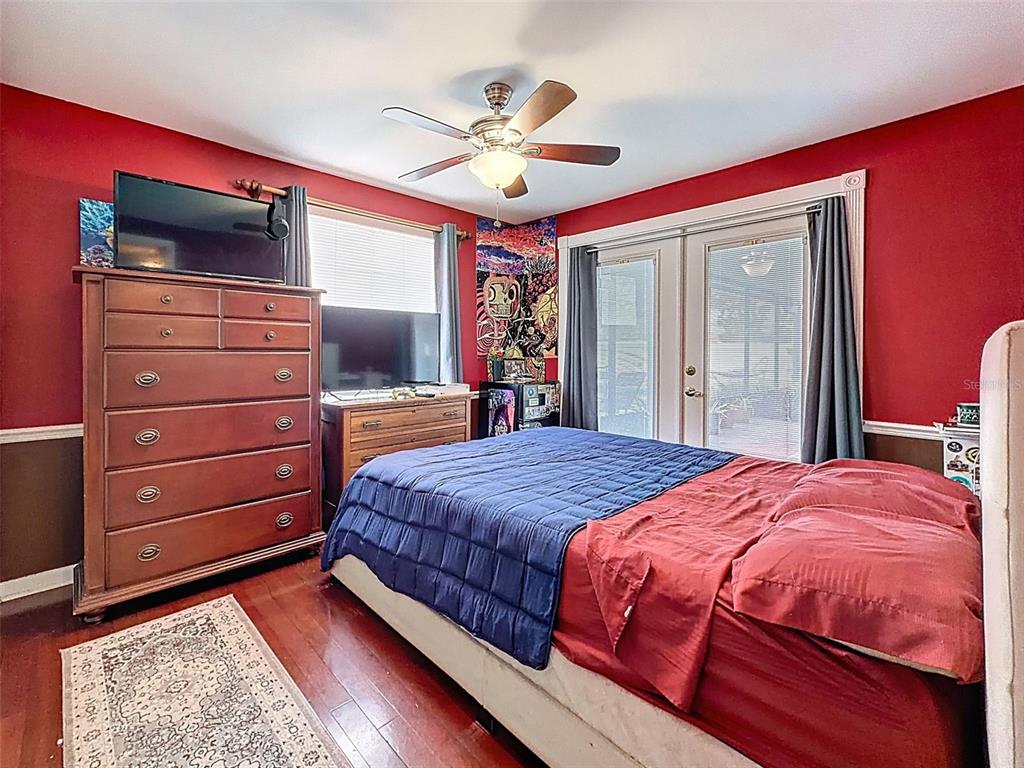 1602 Alder Way Brandon, FL 33510 - Photo 40 of 64 a bedroom with a bed and a chandelier