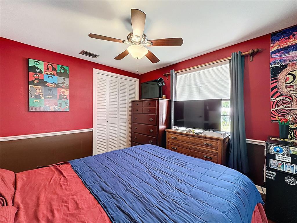 1602 Alder Way Brandon, FL 33510 - Photo 43 of 64 a bedroom with a bed and a flat screen tv