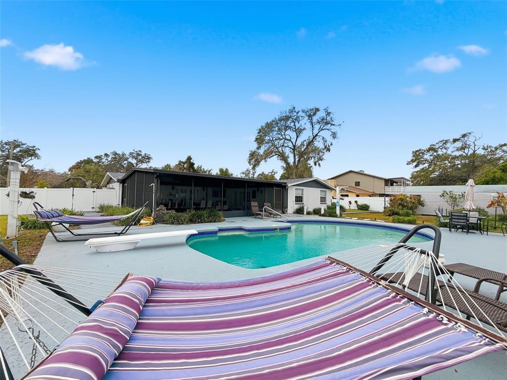 1602 Alder Way Brandon, FL 33510 - Photo 48 of 64 a view of a house with swimming pool and sitting area