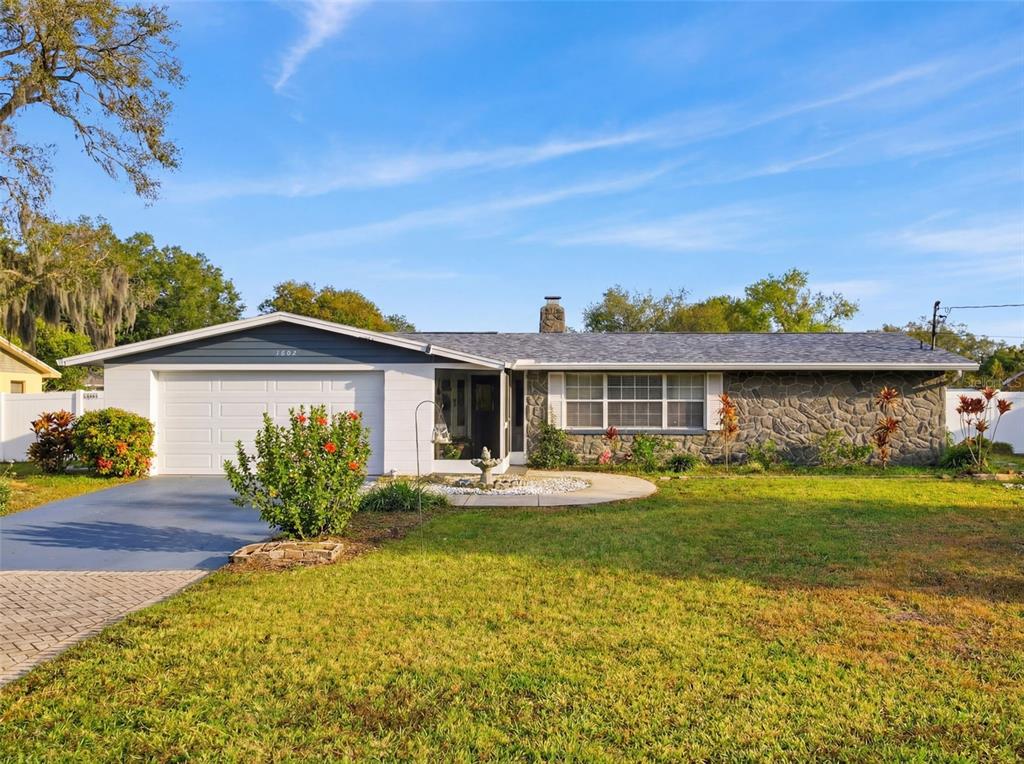 1602 Alder Way Brandon, FL 33510 - Photo 64 of 64 a front view of a house with a garden and deck