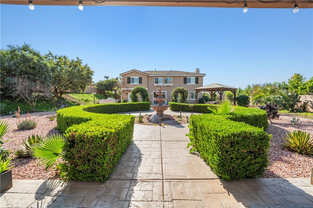 12810 Sierra Creek Drive Riverside, CA 92503 - Photo 15 of 52 a front view of a house with a garden and plants