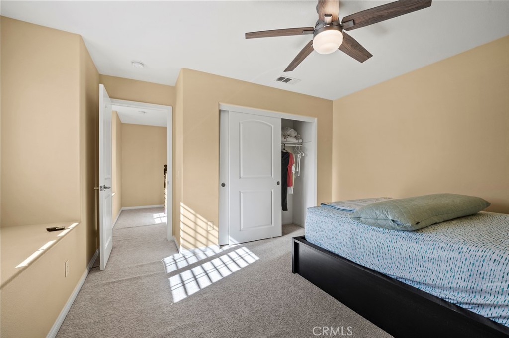 12810 Sierra Creek Drive Riverside, CA 92503 - Photo 21 of 52 a bedroom with a bed and a walk in closet