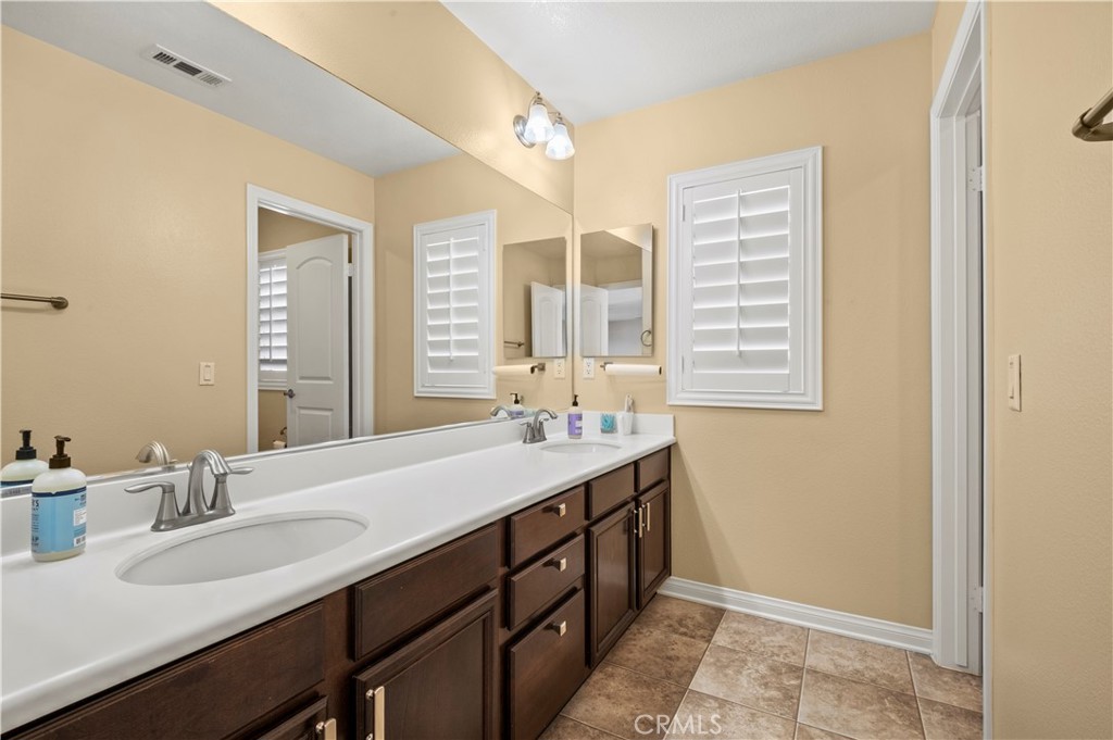 12810 Sierra Creek Drive Riverside, CA 92503 - Photo 25 of 52 a bathroom with a sink double vanity and a mirror