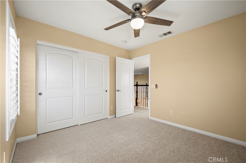 12810 Sierra Creek Drive Riverside, CA 92503 - Photo 29 of 52 an empty room with a ceiling fan and a fan