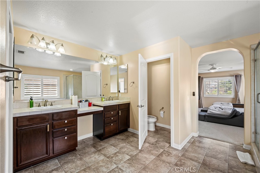 12810 Sierra Creek Drive Riverside, CA 92503 - Photo 34 of 52 a spacious bathroom with a granite countertop sink mirror and a