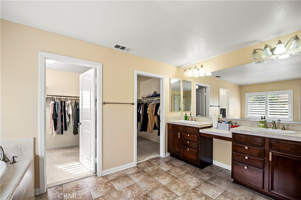 12810 Sierra Creek Drive Riverside, CA 92503 - Photo 35 of 52 a large bathroom with double vanity and a mirror