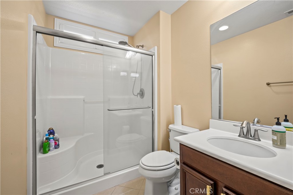 12810 Sierra Creek Drive Riverside, CA 92503 - Photo 52 of 52 a bathroom with a sink toilet and shower