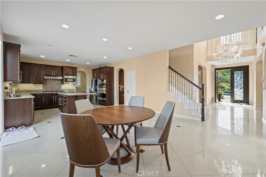12810 Sierra Creek Drive Riverside, CA 92503 - Photo 8 of 52 a dining room with furniture and a kitchen view