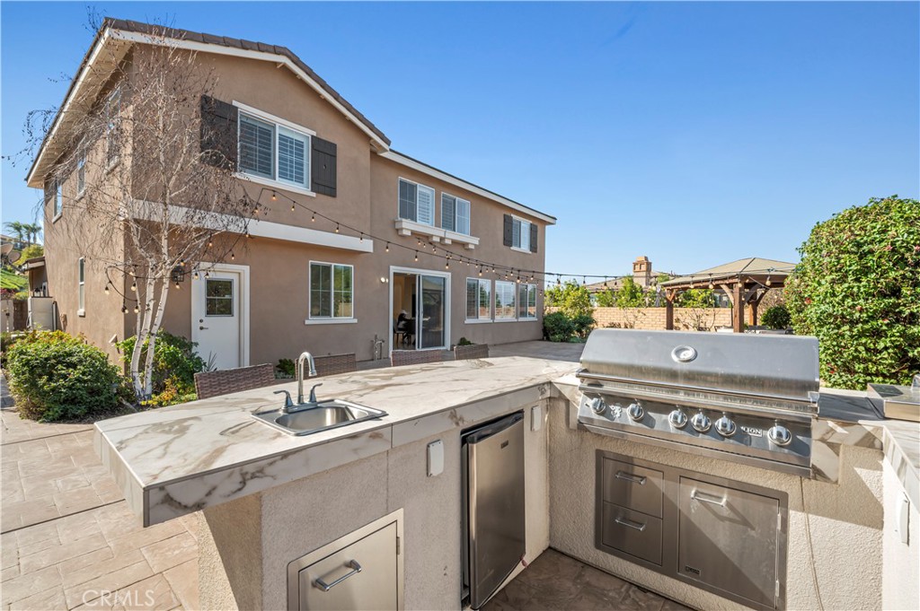 12810 Sierra Creek Drive Riverside, CA 92503 - Photo 10 of 52 a view of a house with a sink and dishwasher