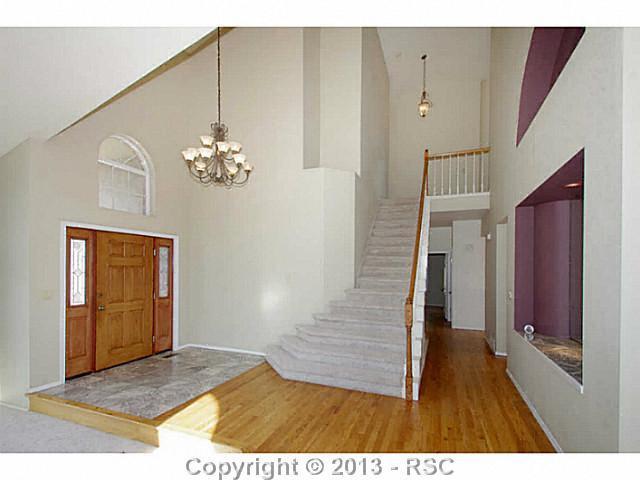 5905 Wilson Road Colorado Springs, CO 80919 - Photo 2 of 25 Tiled Entry Leads to Hardwood Floors That Extend Throughout Most of the Main Level