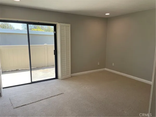 an empty room with sliding glass door