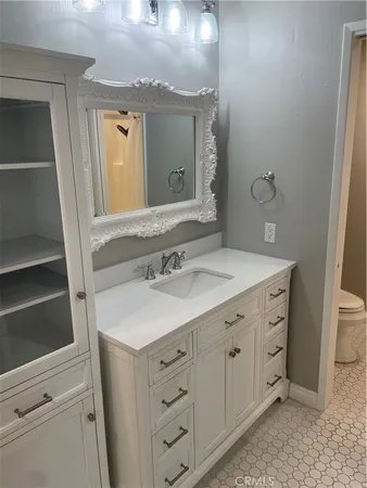 a bathroom with a sink vanity and a mirror
