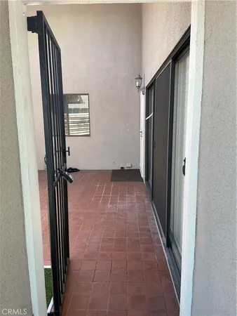 an entryway with hardwood floor and a hallway