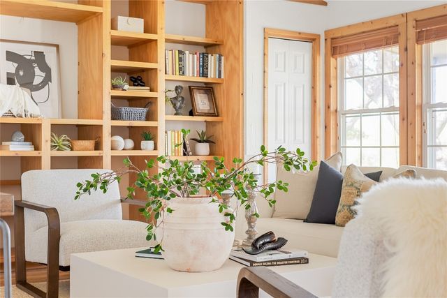 a living room with furniture and flowers