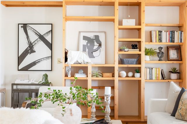 a living room filled with furniture and a book shelf