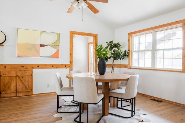 a view of a dining room with furniture and a potted plant