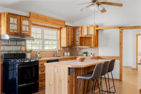 a kitchen that has a stove and a table